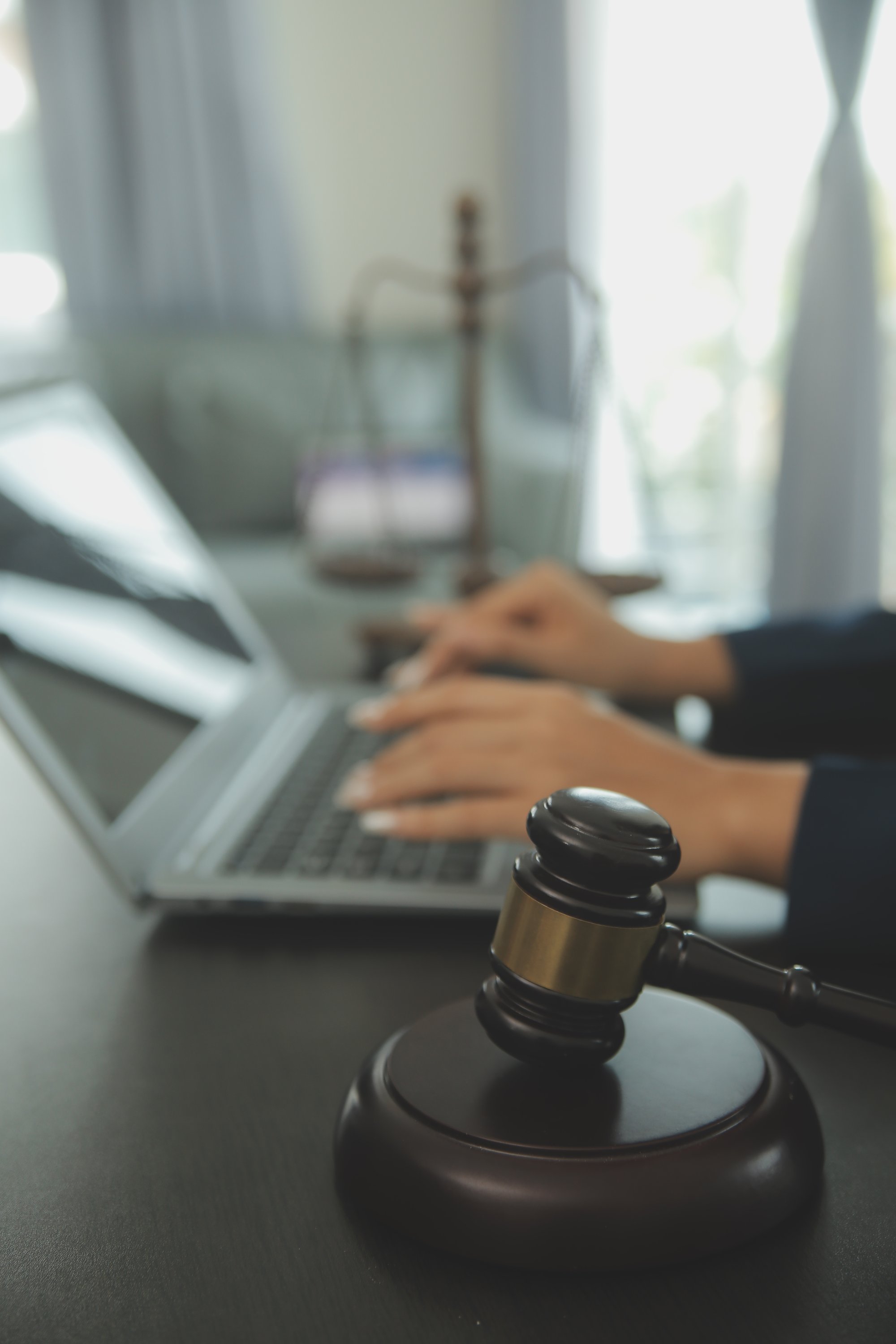 justice-law-conceptmale-judge-courtroom-with-gavel-working-with-computer-docking-keyboard-eyeglasses-table-morning-light